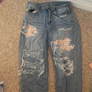 Blue American Eagle jeans with patches under the rips.
